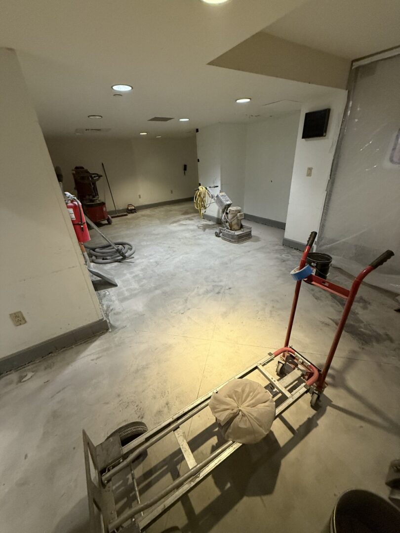 Basement floor renovation with sanding equipment