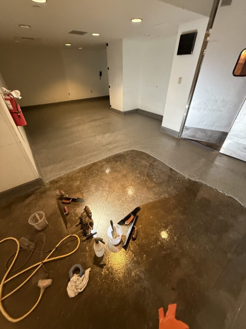 Freshly coated floor in room with tools