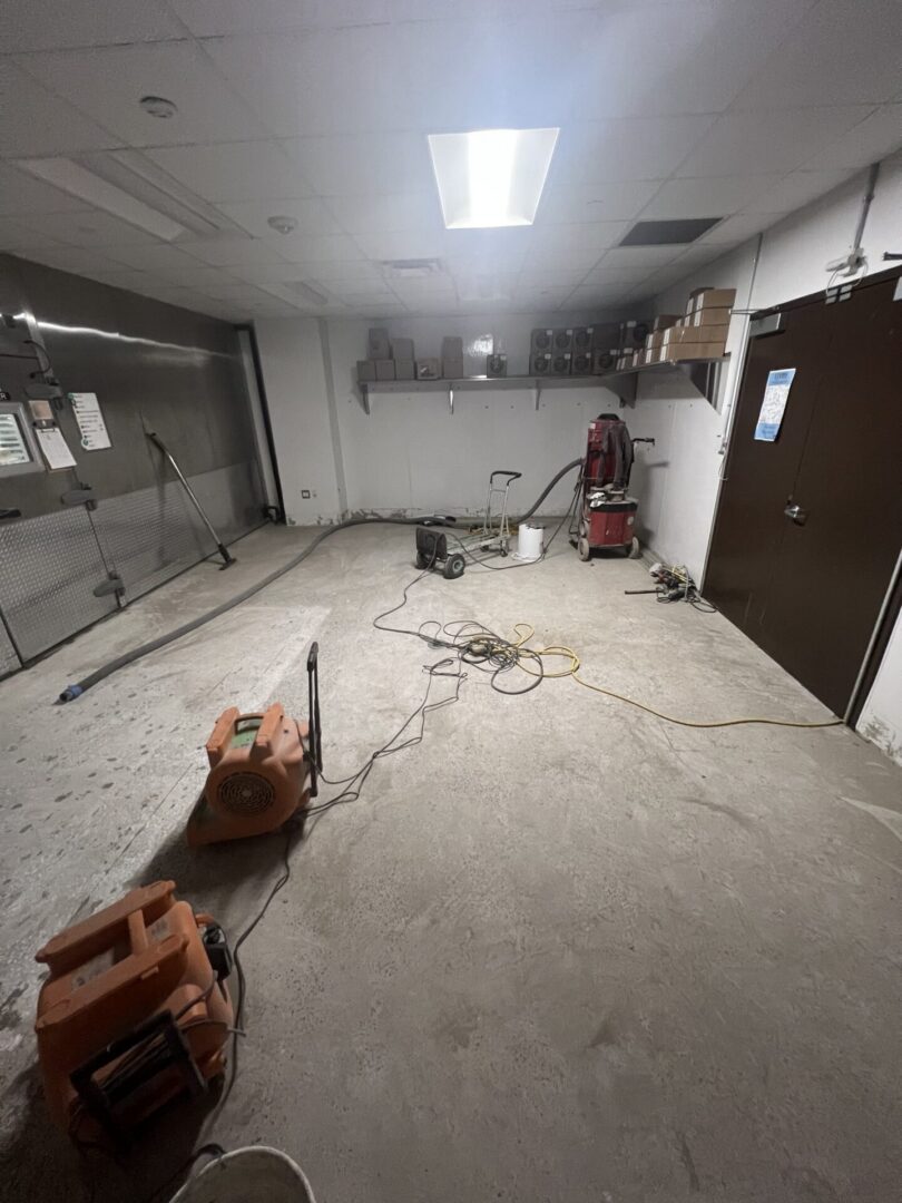 Empty utility room with fans and cords