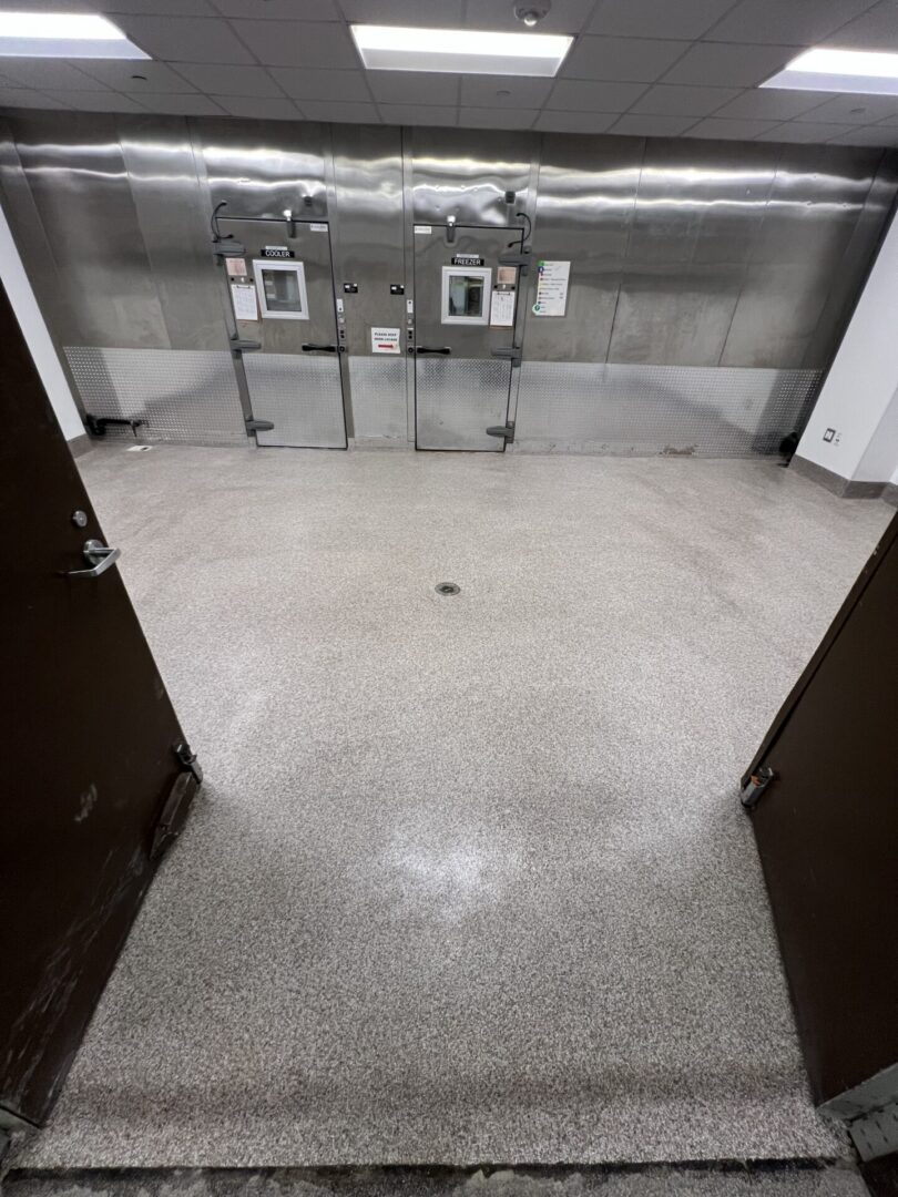Empty commercial walk-in cooler with stainless doors